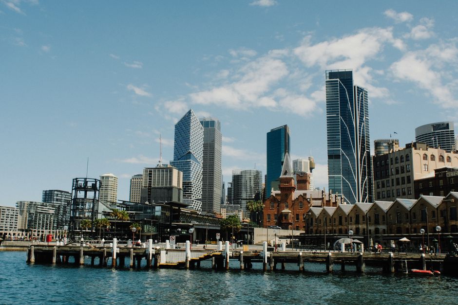 Sydney skyline showcasing modern architecture and vibrant urban life against a blue sky.