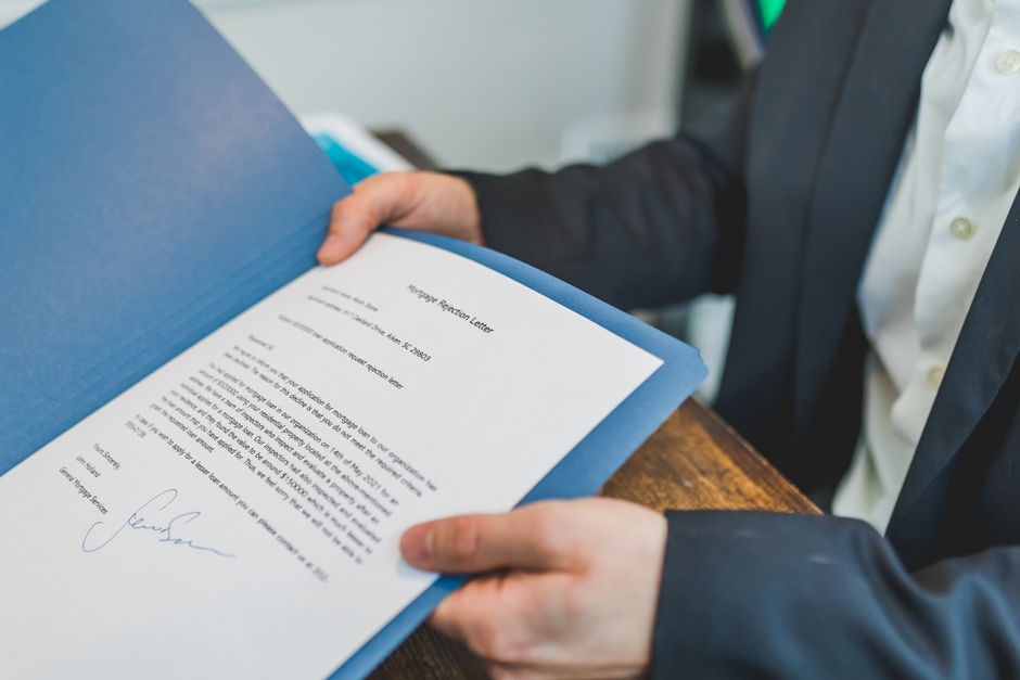Closeup of a real estate contract being reviewed by an agent and client.